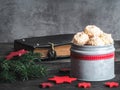Christmas coconut meringue cookies in metal box and old bible on background.