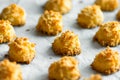 Christmas coconut puffs macaroon cookies on parchment paper on tray. Festive cozy home atmosphere. Holiday pastry baking