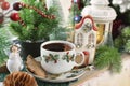 Christmas coffee and gingerbread cookie in house shape on windowsill Royalty Free Stock Photo