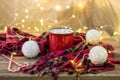 Christmas coffee in a red cup with marshmallows and plaid. Decorated white balls candy cane and light garland bokeh Royalty Free Stock Photo