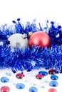 Christmas colored balls in blue tinsel Royalty Free Stock Photo