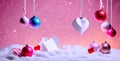 Christmas colorful baubles hanging on snow abstract space with pink background Royalty Free Stock Photo