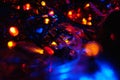 Christmas colorful New Year`s Bokeh neon lights. Abstract Blurred photo background with blinking lights from tangled garlands. Dec Royalty Free Stock Photo