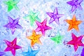 Christmas colorful stars on blue ice