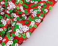 Christmas colours, red, green and silver shiny sequins on large red bow Royalty Free Stock Photo