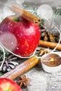 Christmas composition: Apple, candle and cinnamon sticks