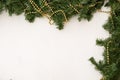 Christmas composition. Christmas background. Green branches of a Christmas tree on a white textured background Royalty Free Stock Photo