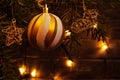 Christmas composition, ball and other decorations on the branches of a Christmas tree on a dark background with lights Royalty Free Stock Photo