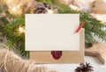 Christmas Composition with a blank card, sealed envelope and fir branches. Holiday mockup