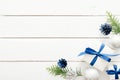 Christmas composition. Blue and silver decorations, balls, gift boxes, pine tree branch on white wooden background. Flat lay, top Royalty Free Stock Photo