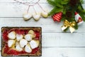 Christmas composition: boots for gifts, decoration fir branch with bright toys, cakes in the form of heart Royalty Free Stock Photo