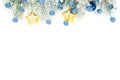 Christmas composition border with blue frozen berries, stars, gold garland and Xmas tree branch isolated on white background. Royalty Free Stock Photo