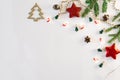 Christmas composition. The border is made of Christmas decoration toys, fir branches, mints and a garland of lights on a white bac Royalty Free Stock Photo