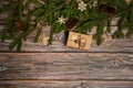 He border is made of gift boxes, fir branches, cones, wooden decorative toys, snowflakes and stars on a wooden background. Christm Royalty Free Stock Photo