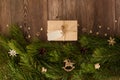 The border is made of gift boxes, fir branches, cones, wooden decorative toys, snowflakes and stars on a wooden background. Chris Royalty Free Stock Photo