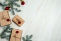 The border is made of gift boxes, fir branches, red bells and balls, on a light marble background. Christmas, winter, New year. Royalty Free Stock Photo