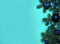 The border is made of spruce branches, white snowflakes, blue balls, ribbons and bows on a light blue background. Royalty Free Stock Photo