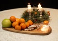 Christmas composition with candle and tangerines