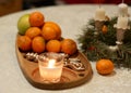 Christmas composition with candle and tangerines