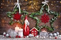 Christmas composition with candles, gnome figurine, photo frame and festive decorations on a wooden background. Christmas or New Royalty Free Stock Photo