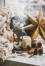 Christmas composition with candles, smoke and decorative toys on windowsill Royalty Free Stock Photo