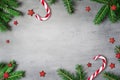 Christmas composition. Christmas candy cane, golden star and fir tree branches. Top view, flat lay Royalty Free Stock Photo