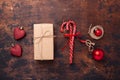 Christmas composition with candy canes, present box and gifts. Red and craft decoration on wooden background Royalty Free Stock Photo