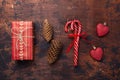 Christmas composition with candy canes, present box and gifts. Red and craft decoration on wooden background Royalty Free Stock Photo