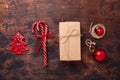 Christmas composition with candy canes, present box and gifts. Red and craft decoration on wooden background Royalty Free Stock Photo