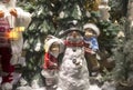 Christmas composition: children and a snowman in the forest. New Year`s decor.