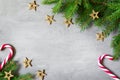 Christmas composition. Christmas candy cane, golden star and fir tree branches. Top view, flat lay Royalty Free Stock Photo