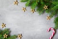 Christmas composition. Christmas candy cane, golden star and fir tree branches. Top view, flat lay Royalty Free Stock Photo