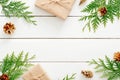 Christmas composition. Christmas fir tree branches, gifts, pine cones on wooden white rustic background. Flat lay, top view. Copy Royalty Free Stock Photo