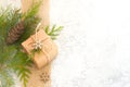 Christmas composition. Christmas gift, jute, pine cone and fir twigs on light background Royalty Free Stock Photo