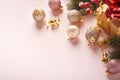 Christmas composition. Christmas pink gift or present box, gold baubles and confetti on pink background. Flat lay, top view. Magic