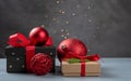 Christmas composition. Christmas presents, red Christmas balls, fir branches on a gray background with fairy lights. Top view, Royalty Free Stock Photo