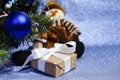 Christmas composition with Christmas tree, gift box and toy snowman. Close-up. Copy space. Concept of congratulations Royalty Free Stock Photo