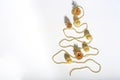 Christmas composition. Christmas tree made of gold bead garland with decorations on white background Royalty Free Stock Photo