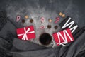 Christmas composition with coffee cup, candy, sugar and gift box on dark. Flat lay, top view Royalty Free Stock Photo