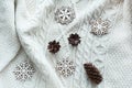 Christmas composition with cone, snowflakes on white knitted sweater. Holiday card. Vintage style. Royalty Free Stock Photo