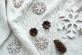 Christmas composition with cone, snowflakes on white knitted sweater. Holiday card. Vintage style. Royalty Free Stock Photo