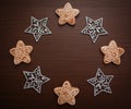 Christmas composition. Cookies and stars. Gingerbread and snowflakes on a wooden background. The decoration of Christmas wreaths. Royalty Free Stock Photo