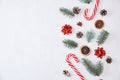 Christmas composition with copy space. Decoration made of fir tree branches, pine cones and sweets on a white background Royalty Free Stock Photo