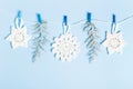 Christmas composition of crocheted white snowflakes and stars on blue background. Top view, flat lay, copy space. Royalty Free Stock Photo