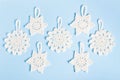 Christmas composition of crocheted white snowflakes and stars on blue background. Top view, flat lay, copy space. Royalty Free Stock Photo