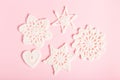 Christmas composition of crocheted white snowflakes and stars on pink background. Top view, flat lay, copy space. Royalty Free Stock Photo