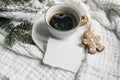 Christmas composition. Cup of coffee, blank cotton card mockup, gingerbread cookie and fir branches on white muslin