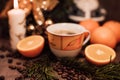 Christmas composition cup of coffee, fruit, candle on a wooden table