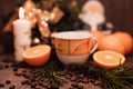 Christmas composition cup of coffee, fruit, candle on a wooden table