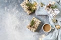 Christmas composition with cup of coffee, knitted blanket, garland and gift on a gray background. Winter, Christmas concept. Flat